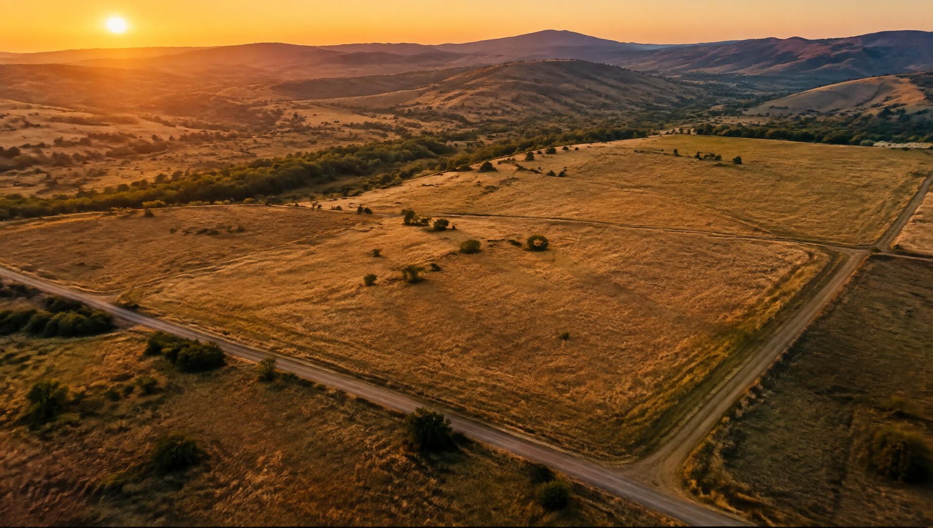 Aerial view of open land parcels at sunset